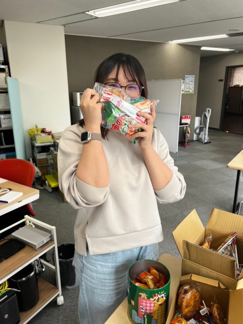 お菓子の摑み取りをする社員